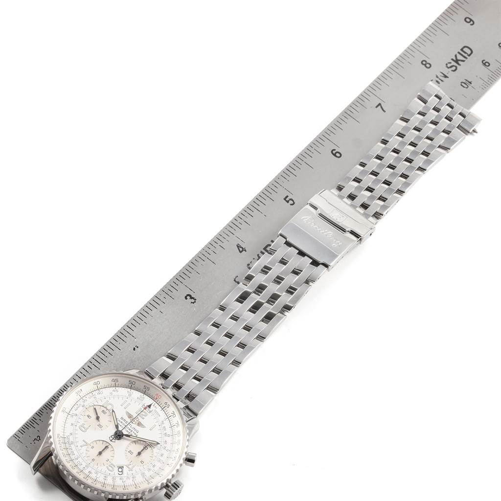 This image shows the Breitling Navitimer A23322 Men
s Stainless Steel Silver Dial A23322 Men
s Stainless Steel Silver Dial watch laying flat with its stainless steel bracelet extended and a ruler for scale.