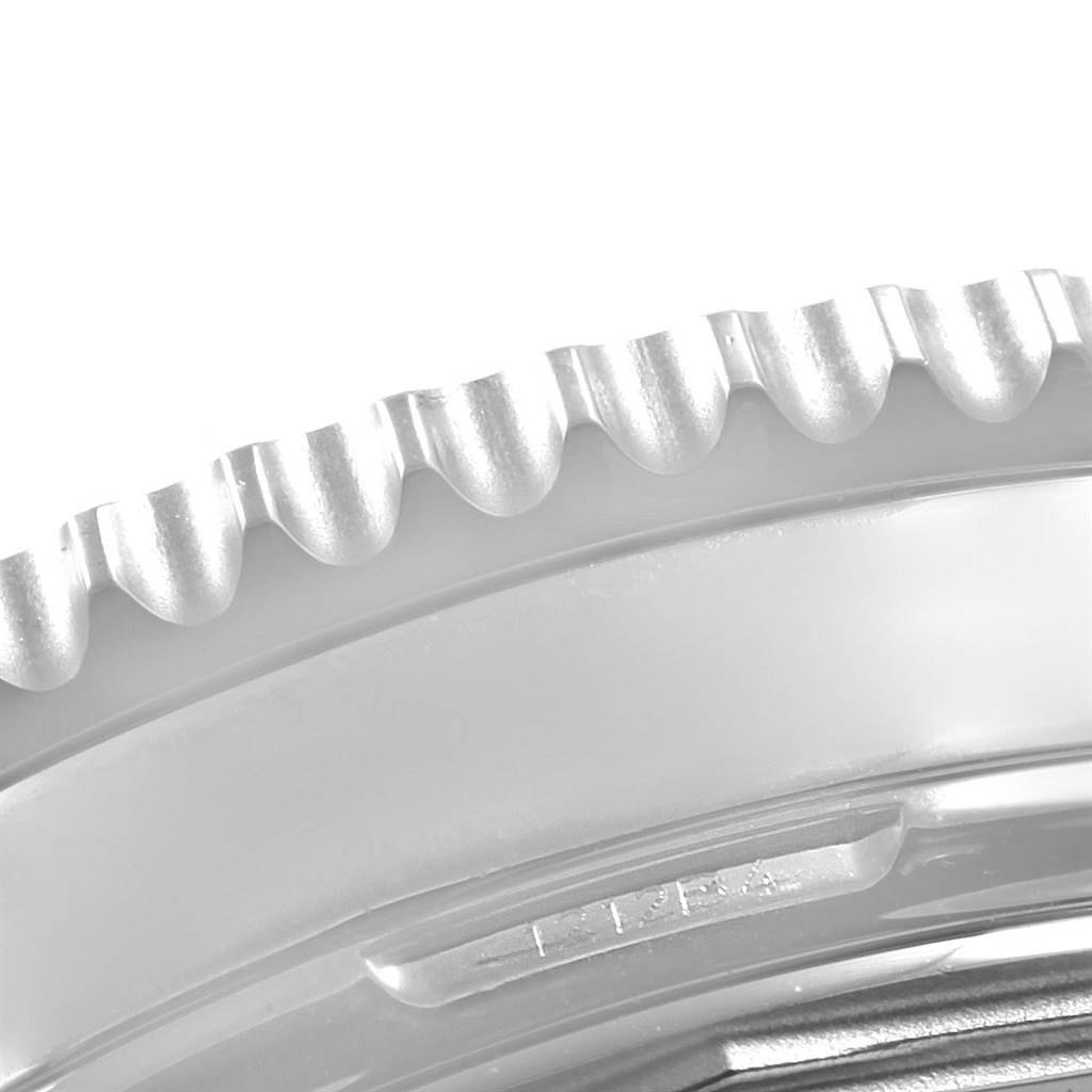 The image shows a close-up angle of the bezel and part of the case of a Breitling Navitimer AB0210 Men's Stainless Steel Black Dial AB0210 Men's Stainless Steel Black Dial watch.