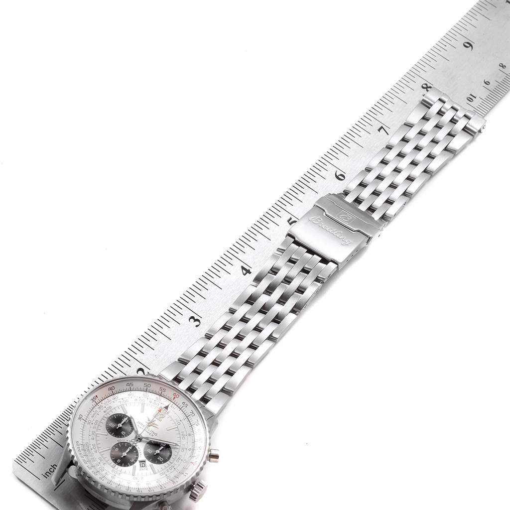 The image shows a Breitling Navitimer A41322 Men
s Stainless Steel Silver Dial A41322 Men
s Stainless Steel Silver Dial watch laid flat with its face and metal bracelet alongside a ruler.