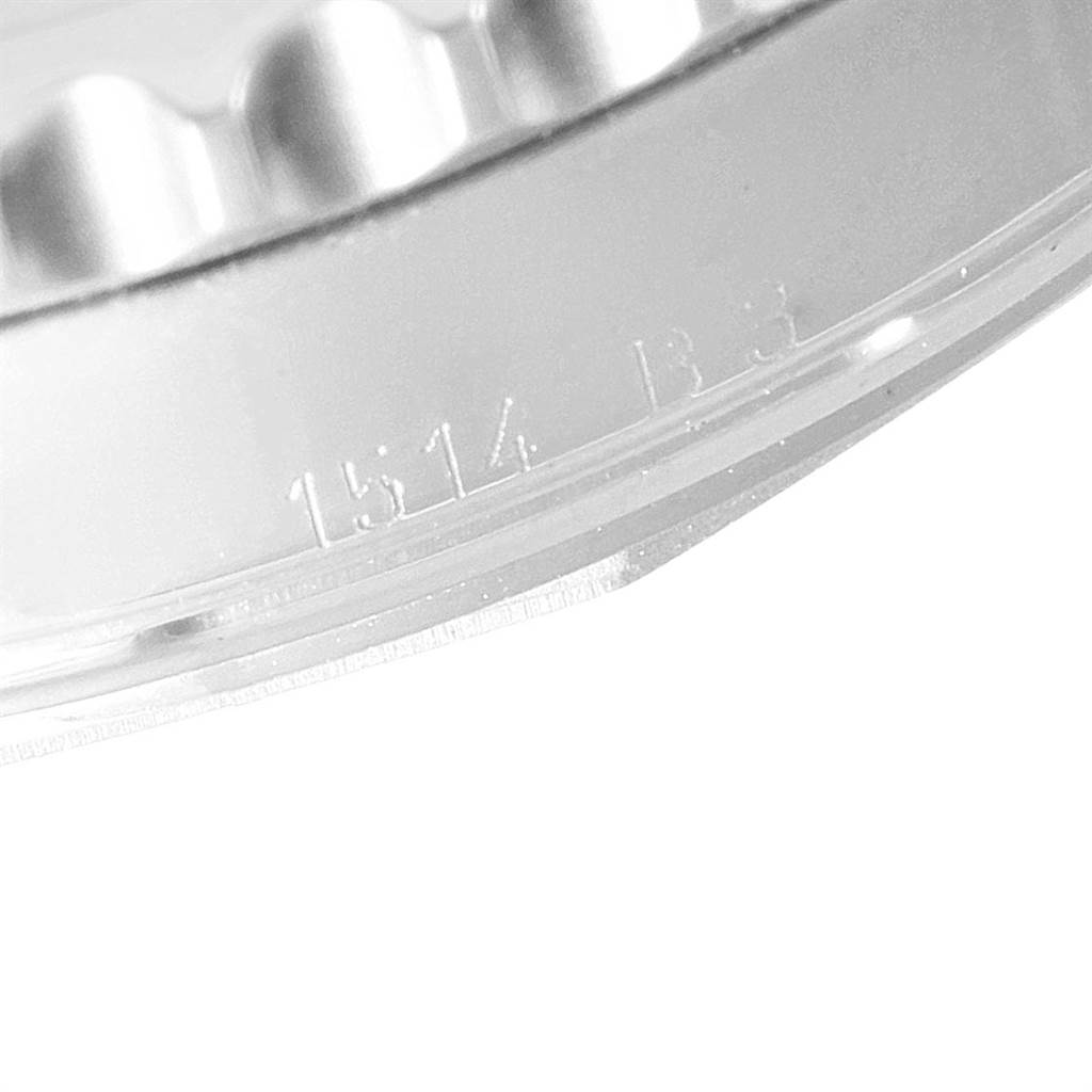 The image shows a close-up angle of the bezel and case edge with engraving on a Breitling Navitimer AB0121C4/Q605 Men's Stainless Steel Brown Dial AB0121C4/Q605 Men's Stainless Steel Brown Dial watch.