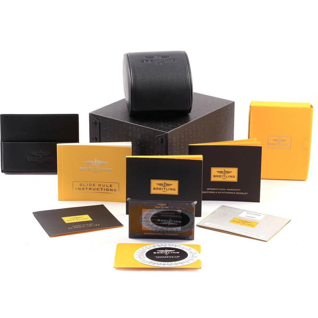 The image shows the packaging and accessories for a Breitling Navitimer AB0121C4/Q605 Men's Stainless Steel Brown Dial AB0121C4/Q605 Men's Stainless Steel Brown Dial watch, including booklets and a watch case.