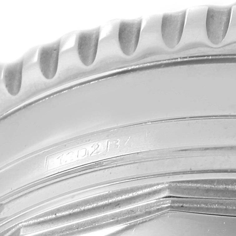 The image shows a close-up of the bezel and part of the case back of a Breitling Navitimer A13322 Men
s Stainless Steel Black Dial A13322 Men
s Stainless Steel Black Dial watch.