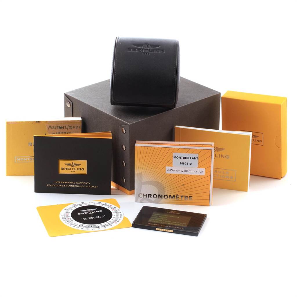 This image shows the packaging and accessories for a Breitling Navitimer A21330 Men's Stainless Steel Brown Dial A21330 Men's Stainless Steel Brown Dial, including booklets, warranty cards, and a watch case.