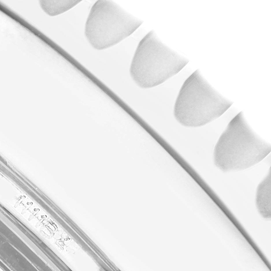 The image shows a close-up angle of the serrated bezel of a Breitling Navitimer AB0131 Men's Stainless Steel Silver Dial AB0131 Men's Stainless Steel Silver Dial watch.