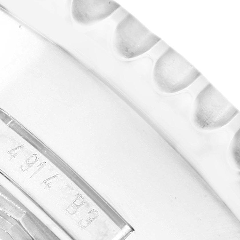 Close-up of the side of a Breitling Navitimer AB012721-C889-453A Men's Stainless Steel Blue Dial AB012721-C889-453A Men's Stainless Steel Blue Dial watch showing part of the bezel and engraved identifiers.