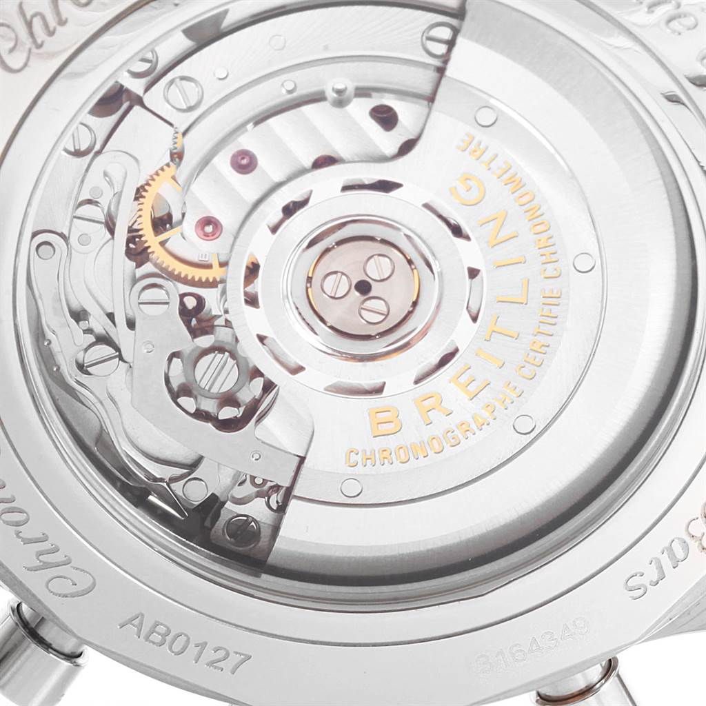 The image shows the back view of a Breitling Navitimer AB012721-C889-453A Men's Stainless Steel Blue Dial AB012721-C889-453A Men's Stainless Steel Blue Dial watch, highlighting the internal mechanical components and inscriptions.