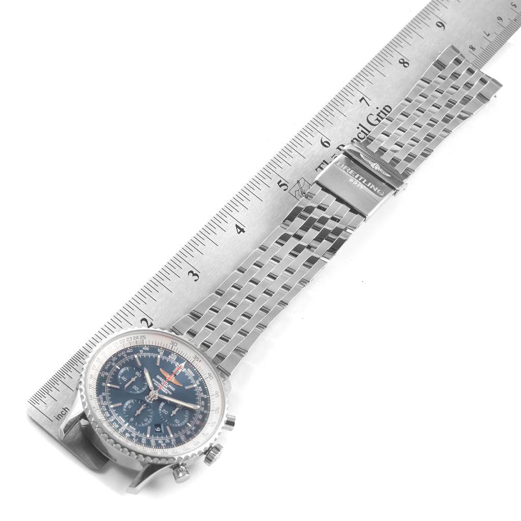 The image shows a Breitling Navitimer AB012721-C889-453A Men's Stainless Steel Blue Dial AB012721-C889-453A Men's Stainless Steel Blue Dial watch laid flat with its metal bracelet extended next to a metallic ruler for measurement.