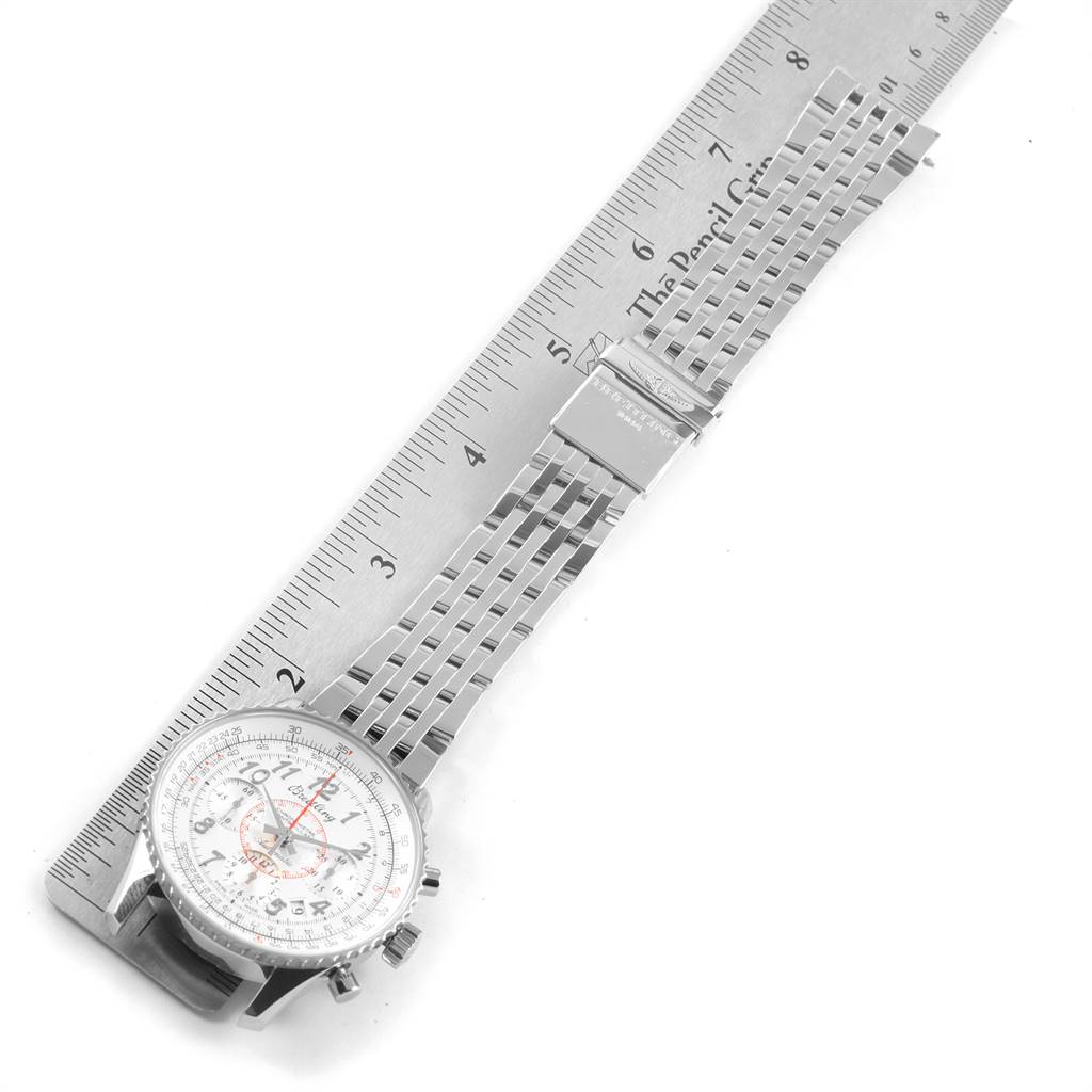 The image shows a top-down view of a Breitling Navitimer AB0131 Men's Stainless Steel Silver Dial AB0131 Men's Stainless Steel Silver Dial watch and its stainless steel bracelet next to a ruler.