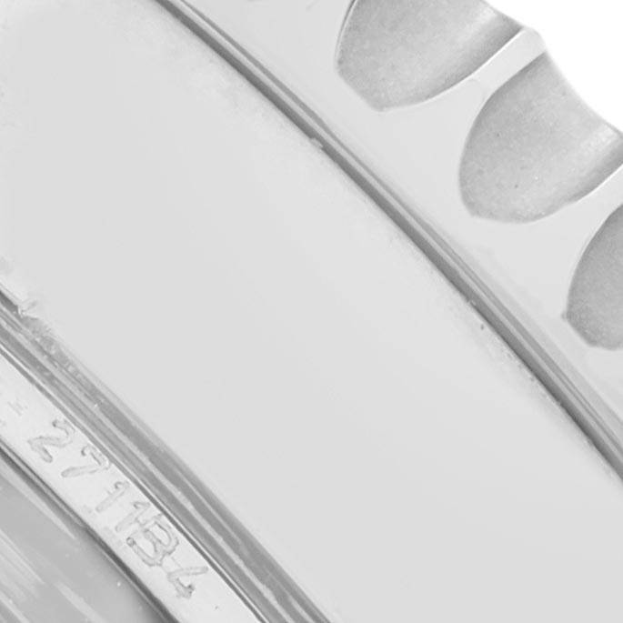This image shows an extreme close-up of the bezel and part of the case of a Breitling Navitimer AB0131 Men's Stainless Steel Silver Dial AB0131 Men's Stainless Steel Silver Dial watch.