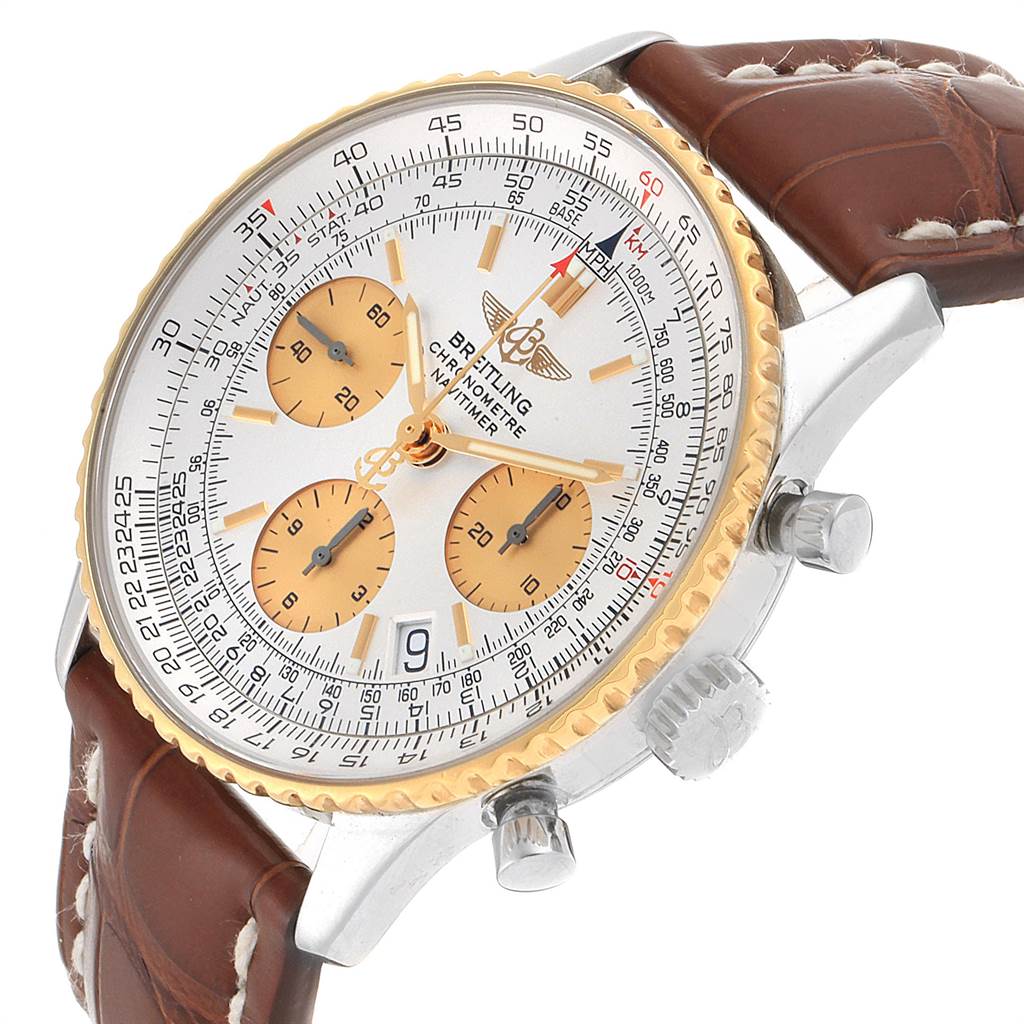 The Breitling Navitimer D23322 Men's Stainless Steel Silver Dial D23322 Men's Stainless Steel Silver Dial watch is shown at an angle, highlighting the face, gold bezel, brown leather strap, and side dials.