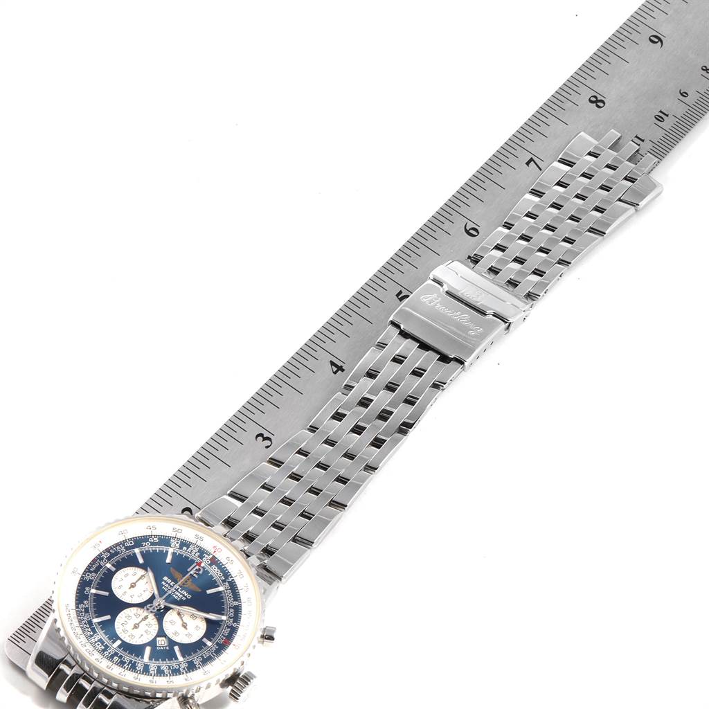 The Breitling Navitimer A35340 Men
s Stainless Steel Blue Dial A35340 Men
s Stainless Steel Blue Dial watch is shown laid flat, displaying the dial, bezel, and metal bracelet with a ruler beside it.