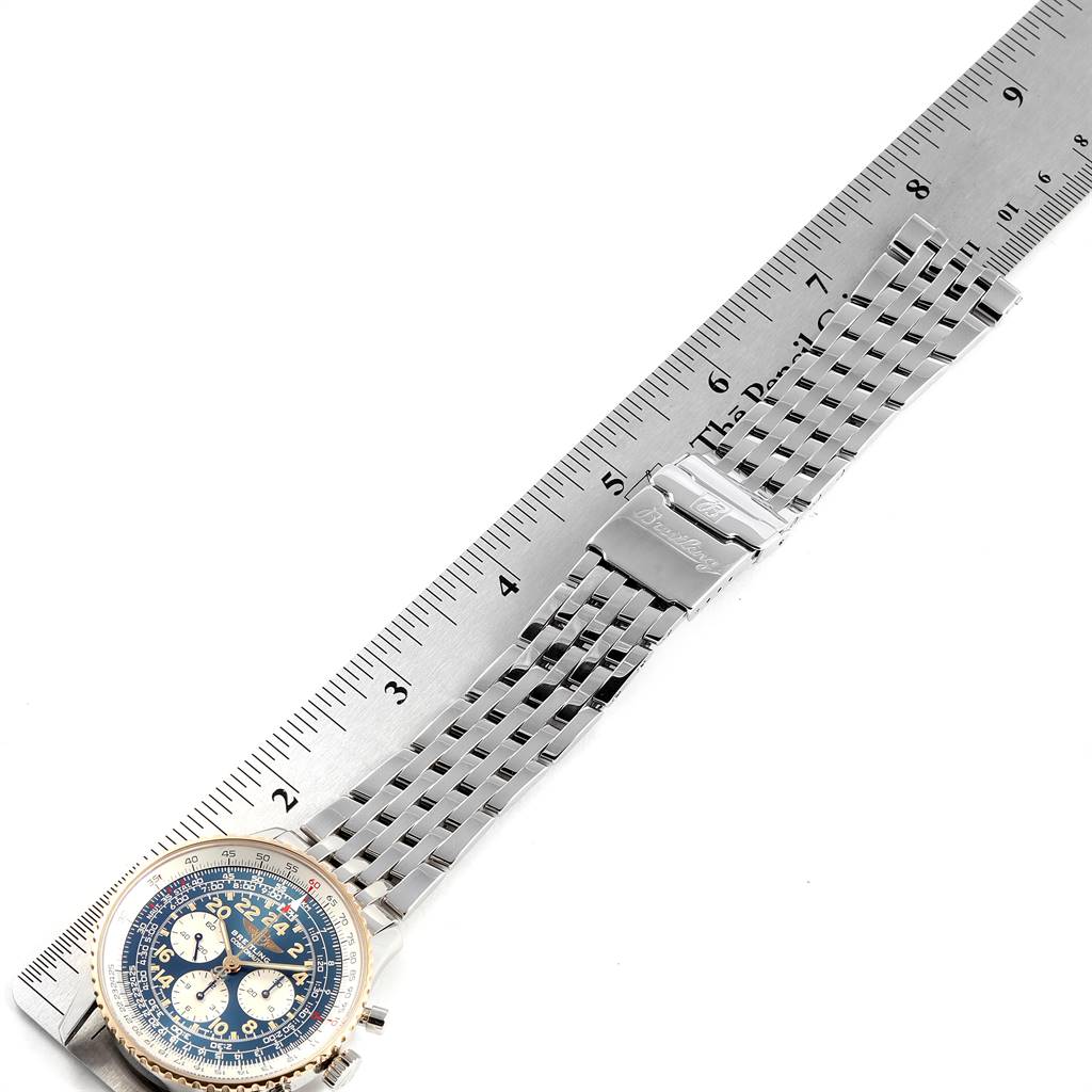 This image shows the Breitling Navitimer D12022 Men's Stainless Steel Blue Dial D12022 Men's Stainless Steel Blue Dial watch laid flat with its metal bracelet against a ruler for measurement.
