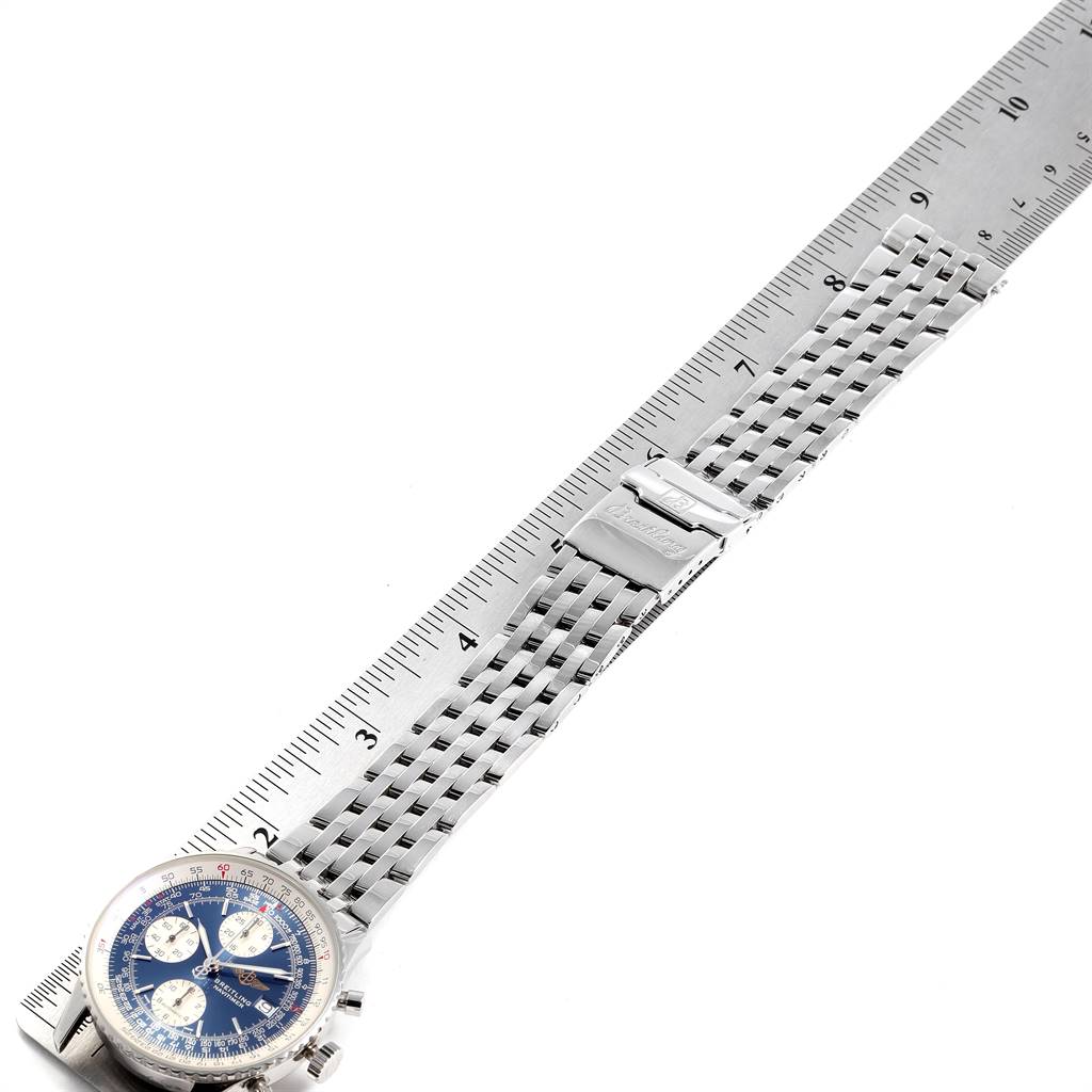 The image shows a Breitling Navitimer A13322 Men's Stainless Steel Blue Dial A13322 Men's Stainless Steel Blue Dial watch with a blue dial and silver strap measured against a ruler.