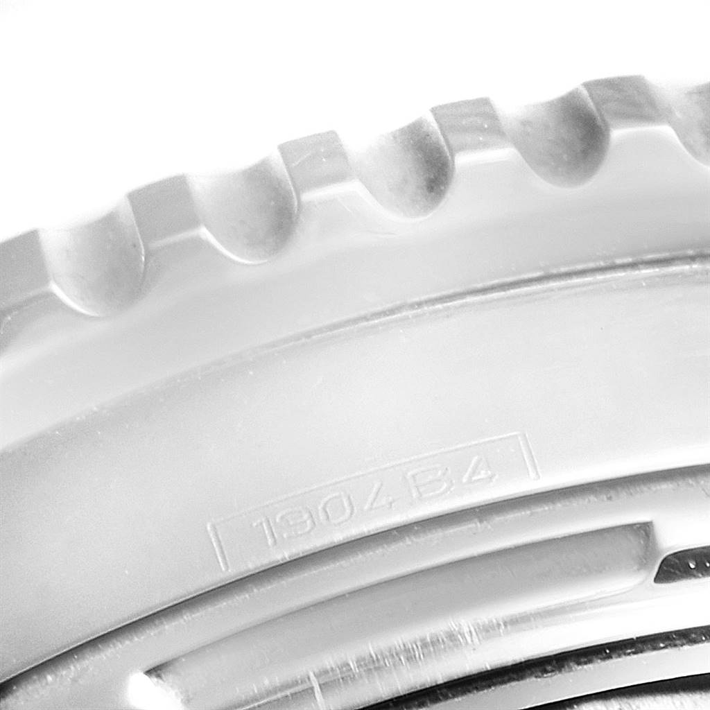 This image shows a close-up of the bezel and part of the casing of a Breitling Navitimer A23322 Men
s Stainless Steel Black Dial A23322 Men
s Stainless Steel Black Dial watch, highlighting its engraved details.