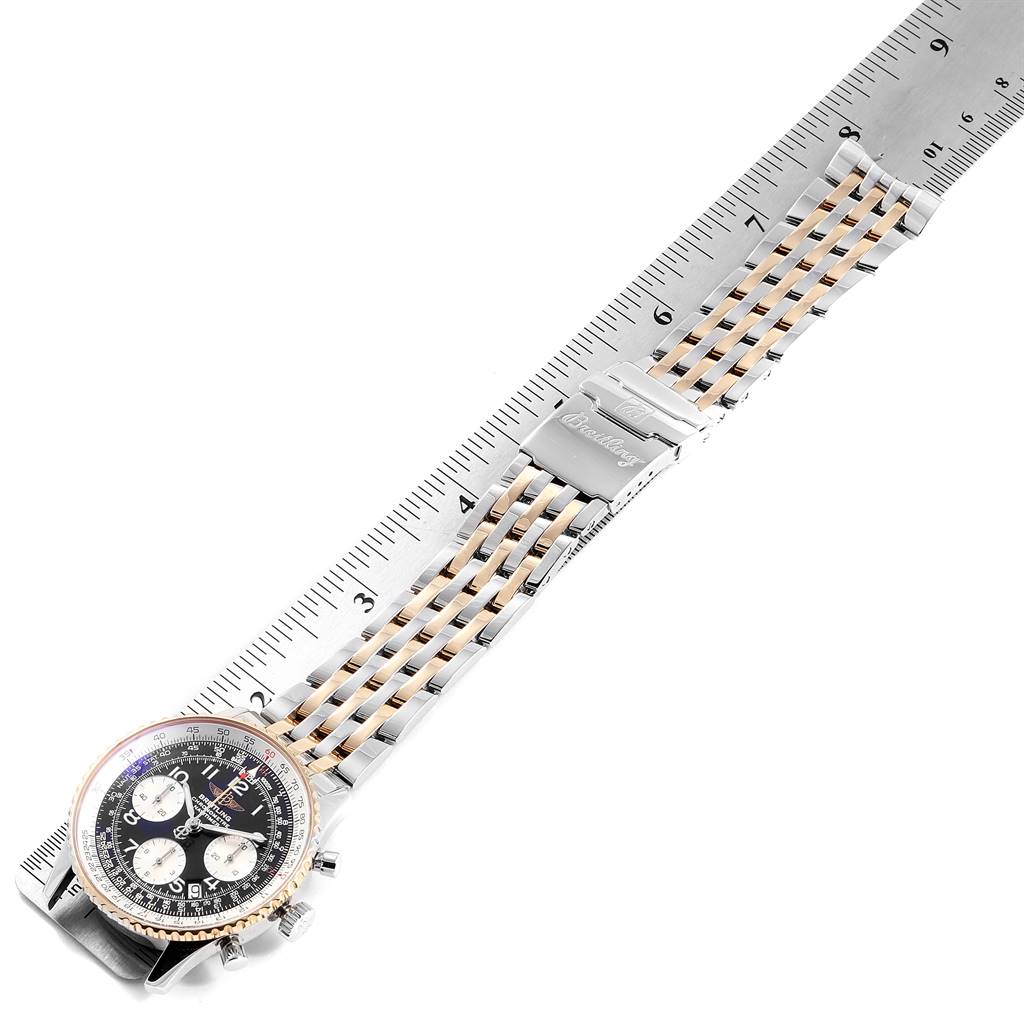 The Breitling Navitimer D23322 Men
s Stainless Steel Black Dial D23322 Men
s Stainless Steel Black Dial watch is shown from a top-down angle, featuring the face, bezel, and full bracelet against a ruler for scale.