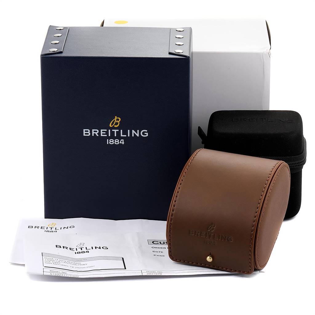 The image shows the accessories from a Breitling Navitimer A13324 Men's Stainless Steel Blue Dial A13324 Men's Stainless Steel Blue Dial watch, including boxes, a leather case, and documents.