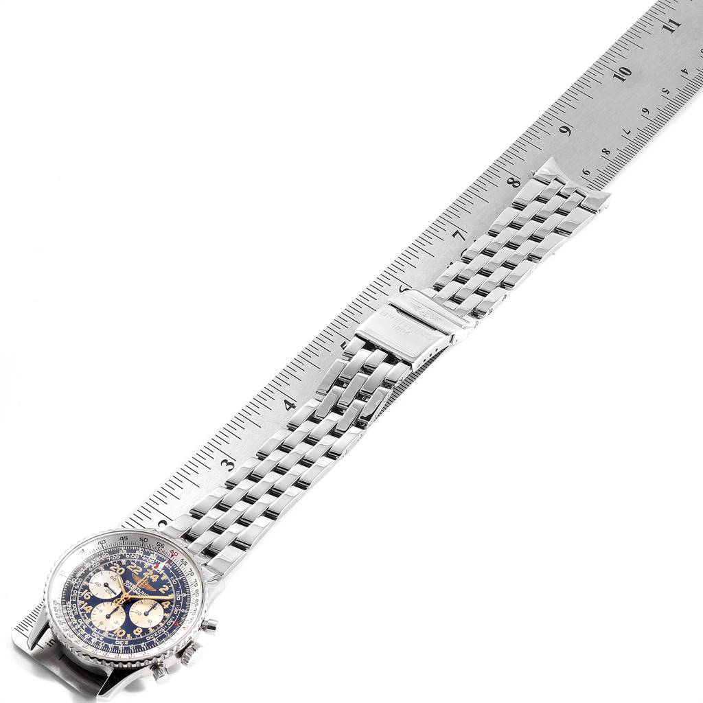 The image shows a Breitling Navitimer D12023 Men
s Stainless Steel Blue Dial D12023 Men
s Stainless Steel Blue Dial watch laid flat alongside a ruler, displaying the watch face and metal band.
