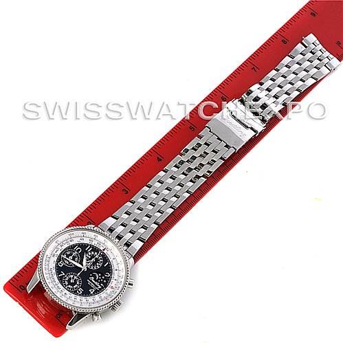 The image shows the full length of a Breitling Navitimer A1935012/B774SS Men's Stainless Steel Black Dial A1935012/B774SS Men's Stainless Steel Black Dial watch from a top-down angle, including the face, bracelet, and clasp, with a red ruler underneath.