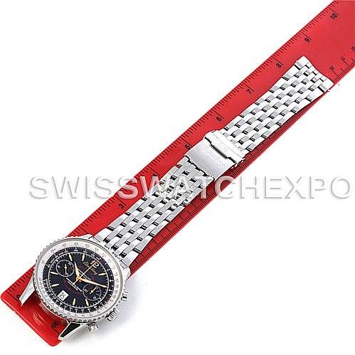 The image shows a top-down view of a Breitling Navitimer A48330 Men's Stainless Steel Black Dial A48330 Men's Stainless Steel Black Dial watch with an extended metal bracelet, placed alongside a red ruler.