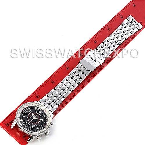 This top-view image shows a Breitling Navitimer A41330 Men's Stainless Steel Black Dial A41330 Men's Stainless Steel Black Dial watch laid out flat on a red ruler, highlighting its face and metal bracelet.