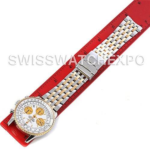 This image shows a top-down view of a Breitling Navitimer D23322 Men
s Stainless Steel Silver Dial D23322 Men
s Stainless Steel Silver Dial watch with its bracelet aligned along a red ruler.