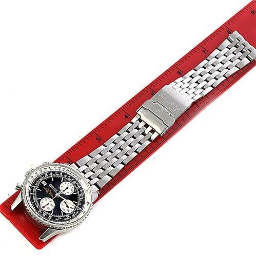 The Breitling Navitimer A13330 Men's Stainless Steel Black Dial A13330 Men's Stainless Steel Black Dial watch is shown from a top-down angle, displaying the face, case, and metal bracelet on a red ruler.