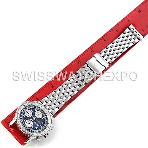 The image shows a top-down view of a Breitling Navitimer A13022 Men's Stainless Steel Blue Dial A13022 Men's Stainless Steel Blue Dial watch with a metal bracelet and clasp, placed next to a red ruler.