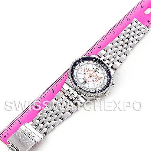 The Breitling Navitimer A23340 Men's Stainless Steel White Dial A23340 Men's Stainless Steel White Dial watch is shown from a top-down angle, displaying its face and metal strap next to a pink ruler for scale.