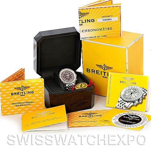 The image shows a Breitling Navitimer A21330 Men
s Stainless Steel Brown Dial A21330 Men
s Stainless Steel Brown Dial watch in an open box, along with various warranty, chronometer, and instruction booklets.