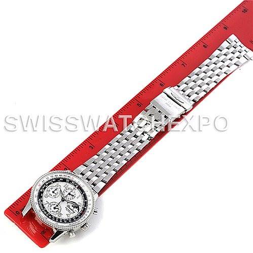 The image shows a Breitling Navitimer A19350 Men
s Stainless Steel Silver Dial A19350 Men
s Stainless Steel Silver Dial watch laid flat with its bracelet extended next to a red ruler.