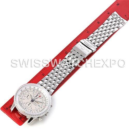 The image shows a Breitling Navitimer A24322 Men's Stainless Steel White Dial A24322 Men's Stainless Steel White Dial watch laid flat, highlighting the face, bezel, and metal bracelet against a red background.