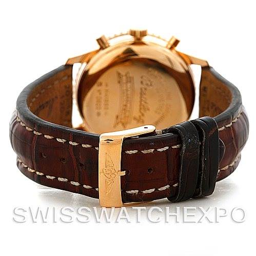 The image shows the back of a Breitling Navitimer H41330 Men's Rose Gold Silver Dial H41330 Men's Rose Gold Silver Dial watch with a leather strap and a gold clasp.