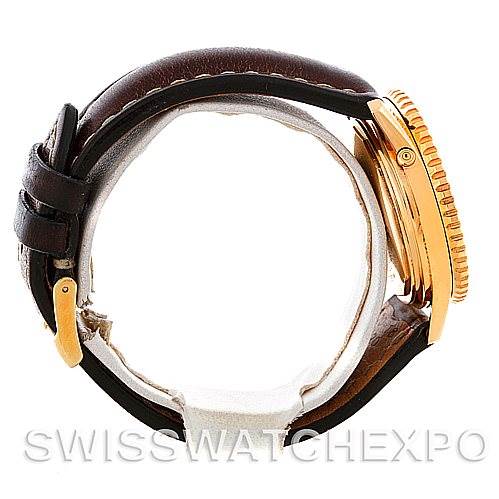 This image shows a side view of the Breitling Navitimer K33030 Men's Yellow Gold Blue Dial K33030 Men's Yellow Gold Blue Dial watch, highlighting the brown leather strap and gold case with the bezel.