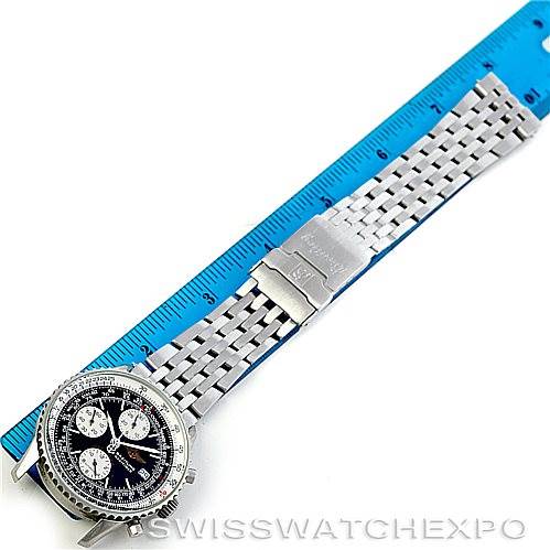 The image shows a top-down view of a Breitling Navitimer A13330 Men's Stainless Steel Black Dial A13330 Men's Stainless Steel Black Dial watch with a stainless steel bracelet next to a blue ruler for scale.