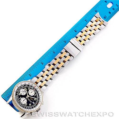 The image shows a Breitling Navitimer D13020 Men's Stainless Steel Black Dial D13020 Men's Stainless Steel Black Dial watch laid flat next to a blue ruler, displaying its dial and metal bracelet from a top-down angle.