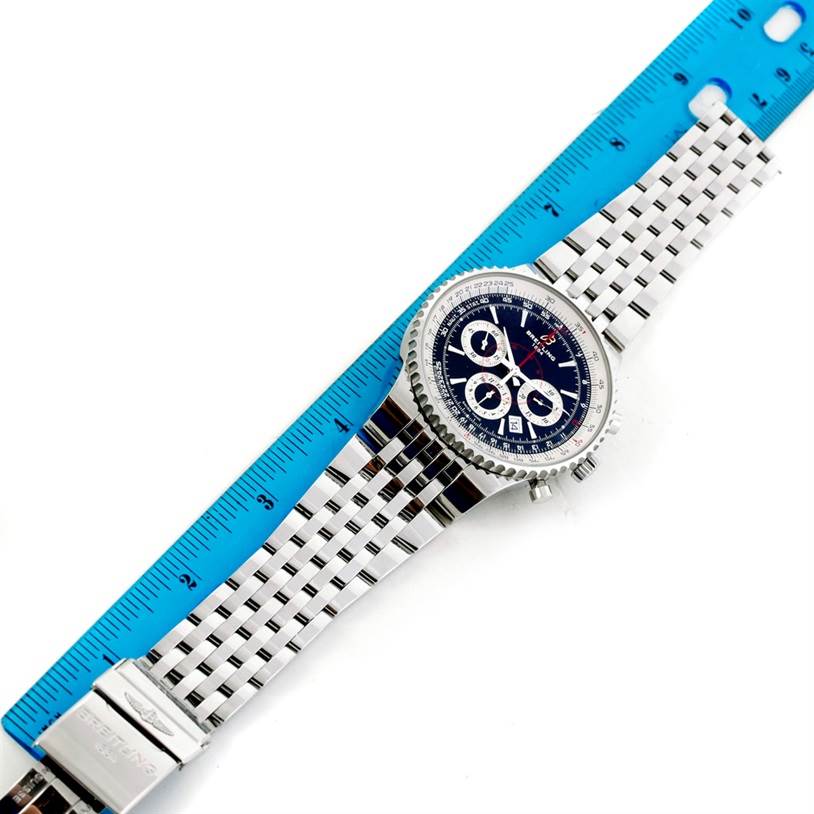 The photo shows the Breitling Navitimer A23351 Men's Stainless Steel Black Dial A23351 Men's Stainless Steel Black Dial watch from a top-down angle, including its face and metal bracelet, alongside a blue ruler.