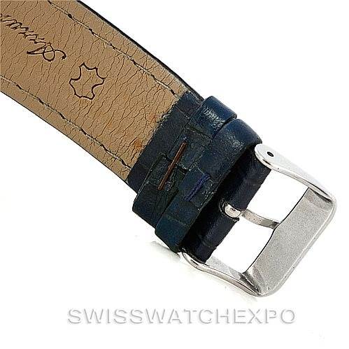 The image shows a close-up of the buckle and leather strap of a Navitimer model by Breitling.