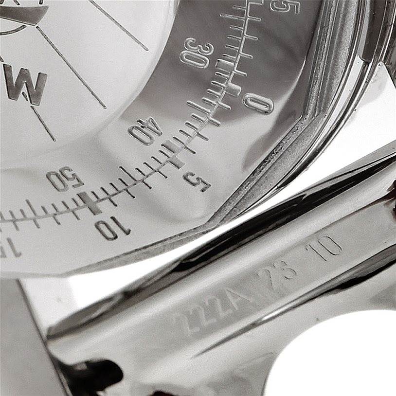 This close-up image shows the bezel and part of the dial, including numbers, of a Navitimer model by Breitling.