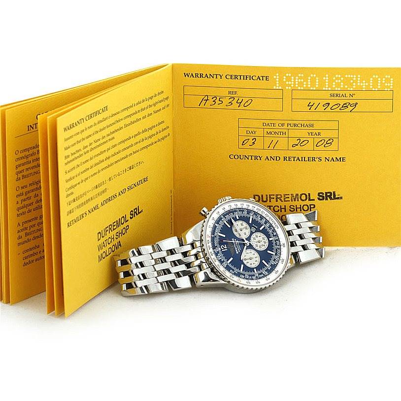 The image shows the Breitling Navitimer A35340 Men's Stainless Steel Blue Dial A35340 Men's Stainless Steel Blue Dial watch at a slight angle, with its warranty certificate booklet in the background.