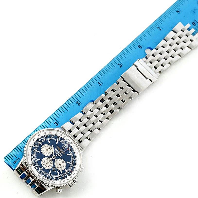 The Breitling Navitimer A35340 Men's Stainless Steel Blue Dial A35340 Men's Stainless Steel Blue Dial watch is shown from a top view, displaying the face, bezel, and metal bracelet next to a ruler for scale.