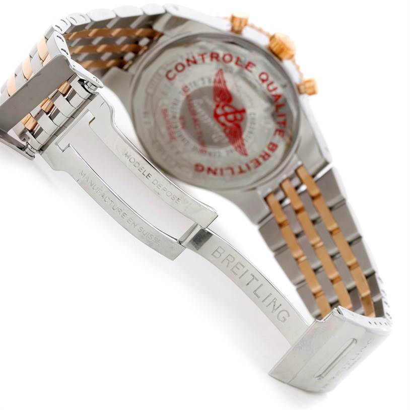 The image shows the back view and stainless steel bracelet of a Breitling Navitimer C23340 Men's Steel and Gold (two tone) Silver Dial C23340 Men's Steel and Gold (two tone) Silver Dial watch with engravings and clasp details.