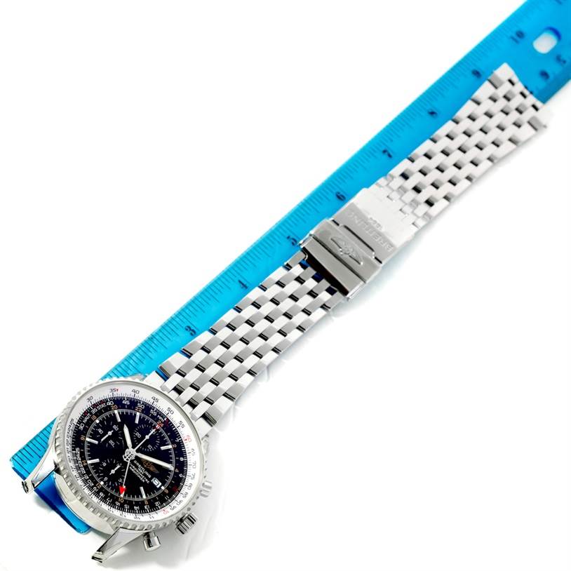 The image shows a top view of a Breitling Navitimer A24322 Men
s Stainless Steel Black Dial A24322 Men
s Stainless Steel Black Dial watch, emphasizing its face, metal bracelet, and clasp against a blue ruler.