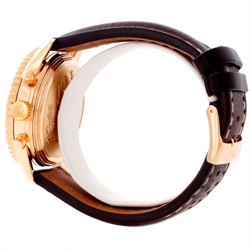 The image shows the side view of a Breitling Navitimer H48330 Men's Rose Gold Black Dial H48330 Men's Rose Gold Black Dial watch, focusing on the case, crown, and clasped leather strap.