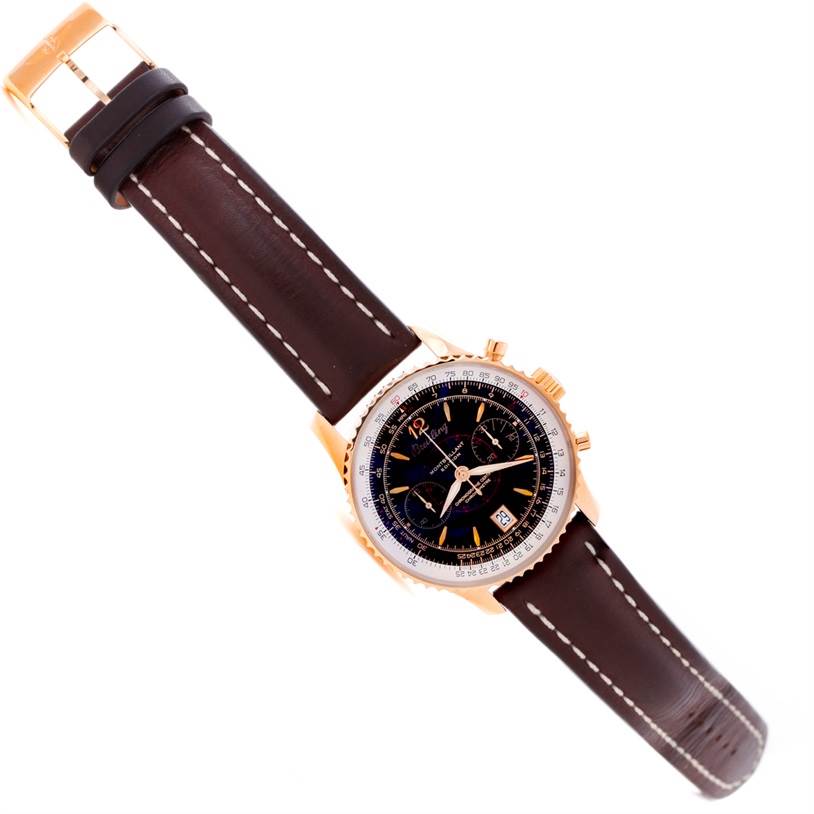 The Navitimer model by Breitling is shown at an oblique angle, highlighting its dial, casing, and leather strap.