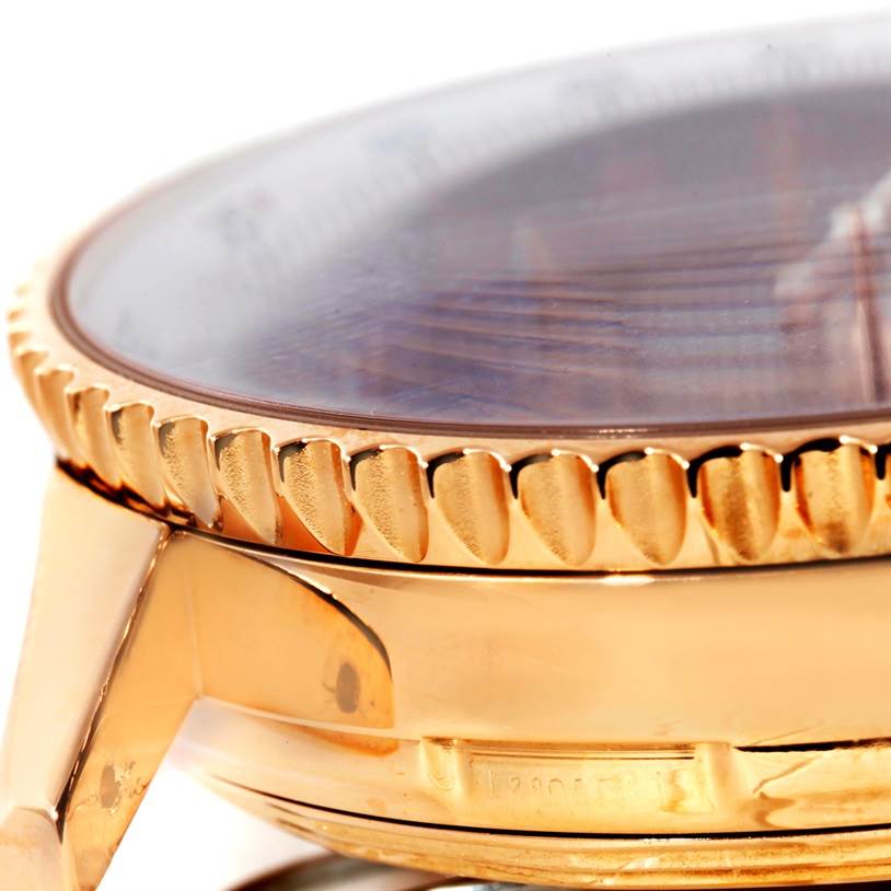 The image shows a close-up side angle of a Breitling Navitimer H48330 Men's Rose Gold Black Dial H48330 Men's Rose Gold Black Dial watch, highlighting the bezel and part of the case.