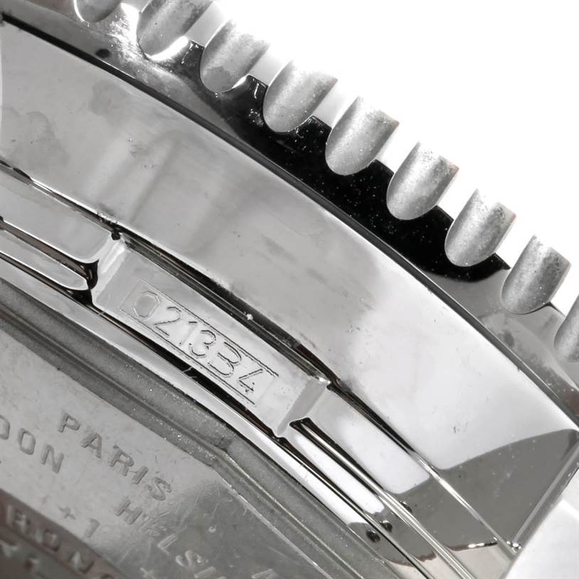 This close-up image of a Breitling Navitimer A24322 Men's Stainless Steel White Dial A24322 Men's Stainless Steel White Dial watch shows the edge of the bezel and part of the case back with an engraved serial number.