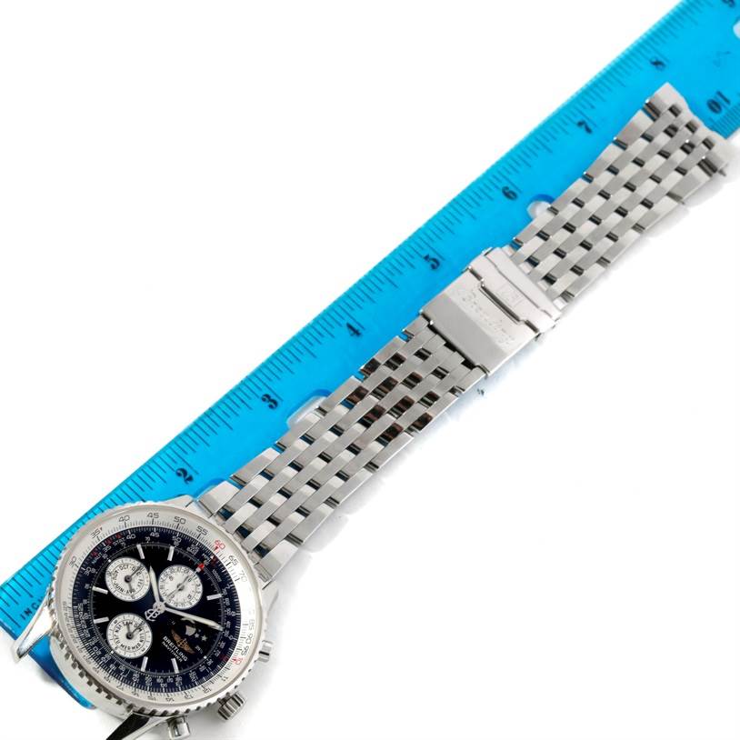 The image shows a Breitling Navitimer A19340 Men's Stainless Steel Black Dial A19340 Men's Stainless Steel Black Dial watch laid flat next to a ruler, highlighting its face, bezel, and metal bracelet.