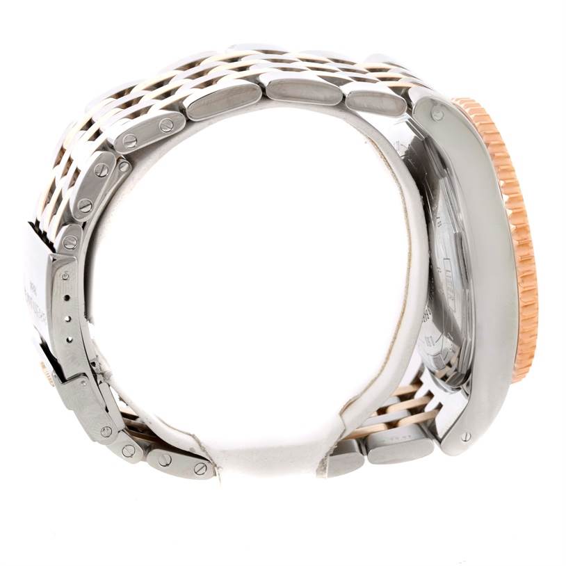 The image shows the side profile of a Breitling Navitimer C23340 Men
s Steel and Gold (two tone) Black Dial C23340 Men
s Steel and Gold (two tone) Black Dial watch highlighting its metal strap and bezel.