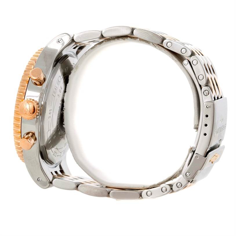 The image shows a side view of a Breitling Navitimer C23340 Men
s Steel and Gold (two tone) Black Dial C23340 Men
s Steel and Gold (two tone) Black Dial watch, highlighting its crown, pushers, and metal bracelet.