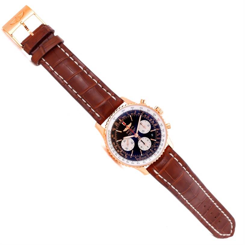 The Breitling Navitimer RB0120 Men's Rose Gold Black Dial RB0120 Men's Rose Gold Black Dial watch is shown from a top-down angle, displaying its face, brown leather strap, and gold case with three subdials.
